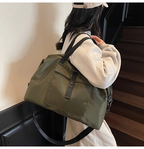 Close-up of military green travel bag with large capacity and adjustable shoulder strap