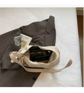 Spacious interior of beige shoulder bag showing capacity for phones and daily essentials