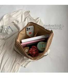 Top-down view of large color-block straw tote bag interior with multiple storage pockets
