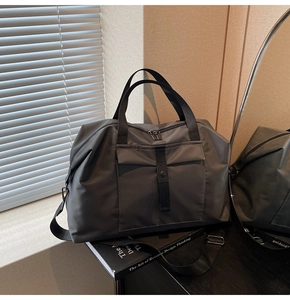 Close-up of waterproof nylon travel bag featuring reinforced handles and buckle details