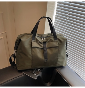 Close-up of military green waterproof travel bag with buckle pocket and dual metal zippers