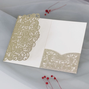 Detailed laser-cut mandala wedding invitation with elegant gold glitter finish