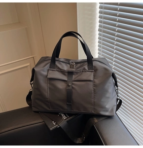 Detailed view of large charcoal gray travel bag with durable nylon fabric and front pocket