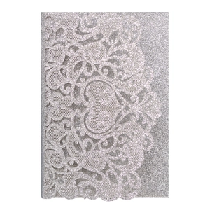 Detailed laser-cut lace texture of silver glitter wedding invitation with floral patterns