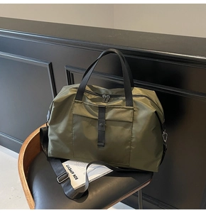 Detailed view of the water-resistant army green nylon fabric on the large travel bag