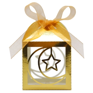 Detail of golden hollow gift box with moon and star pattern and yellow ribbon