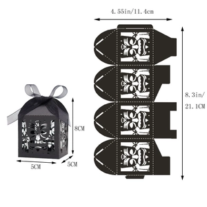 Detail of black laser-cut Tiki mask favor box with ribbon and dimensions shown