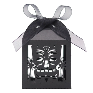 Laser-cut black gift box featuring hollow Tiki totem and coconut tree silhouette patterns
