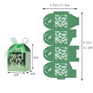 Macro detail of laser-cut green leaf favor box with satin ribbon and dimensions