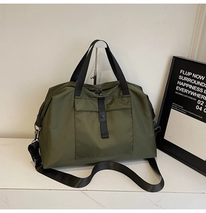 Macro detail of olive green waterproof nylon travel bag with heavy-duty metal zippers