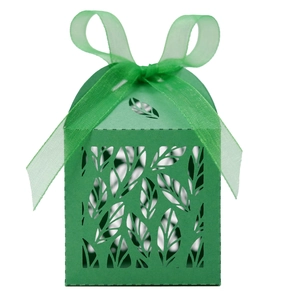 Close-up of laser-cut leaf pattern on green gift box with matching organza ribbon