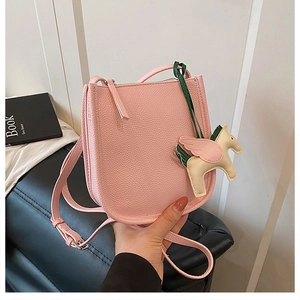 Pink lychee texture bucket bag with a decorative leather Pegasus charm detail