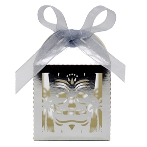 Detail of silver laser-cut gift box featuring skull patterns and light blue ribbon