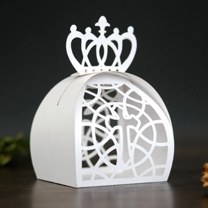 Detailed laser-cut white candy box featuring a crown top and intricate geometric patterns