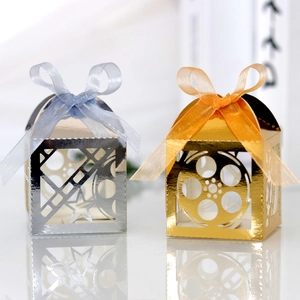 Detail of film theme candy boxes with hollow movie reel patterns and satin ribbons