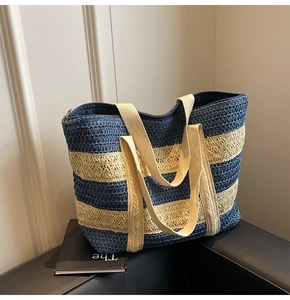 Close-up of contrast striped straw tote bag showing woven texture and canvas straps
