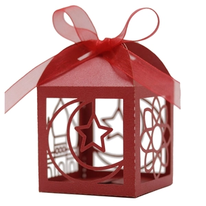 Detail showing red hollowed paper candy box with lantern shape and ribbon bow