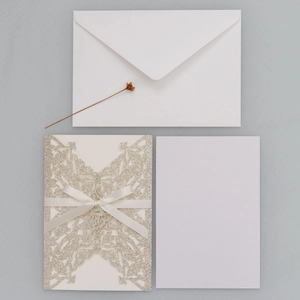 Champagne glitter laser-cut wedding invitation set with white ribbon and envelope