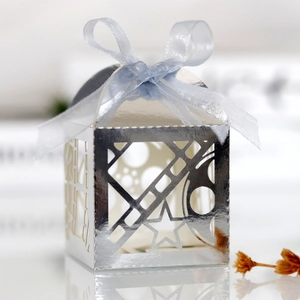 Detailed view of silver hollow-out candy box with a light blue chiffon ribbon bow