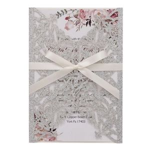 Silver glitter laser cut wedding invitation with white ribbon and floral insert