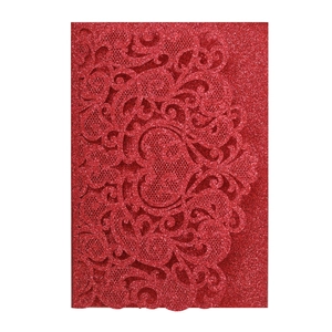 Detail of red laser-cut wedding invitation with glitter baroque pattern and heart motif