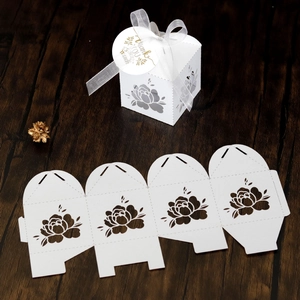 Detail of white laser-cut floral wedding candy box with Thank You tag and white silk ribbon
