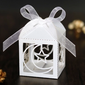 White hollow candy box with laser-cut moon and stars and a white ribbon bow for Eid