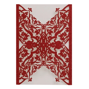 Red glitter laser-cut invitation sleeve with intricate European floral hollow design