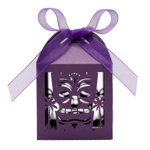 Detail of laser-cut purple gift box with tribal mask and tropical palm tree pattern