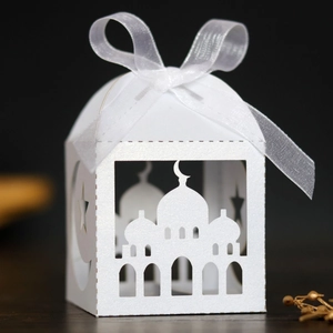Macro view of white laser-cut gift box with mosque pattern and star-moon details