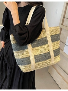 Large striped straw tote bag for summer beach travel with durable fabric handles