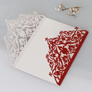 Detailed laser-cut wedding invitation with red glitter hollow patterns and white cover