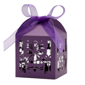 Purple laser cut party gift box with Tiki mask hollow pattern and matching silk ribbon