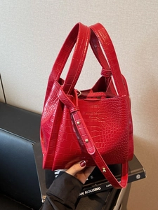 Elegant red crocodile pattern bucket bag with golden hardware and adjustable strap