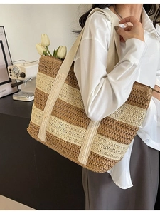 Large contrast stripe straw tote bag for women shown in a stylish lifestyle scene