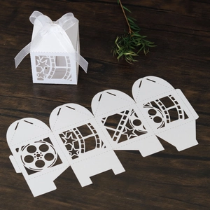 Detailed laser cut movie themed candy box with film strip design and white ribbon bow