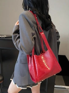 Chic red crocodile pattern bucket bag with gold hardware and adjustable strap