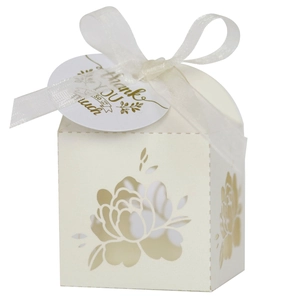 Detail of laser-cut rose hollow favor box with ivory ribbon and golden Thank You tag