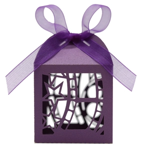 Detail of purple laser cut candy box with star patterns and matching organza ribbon bow