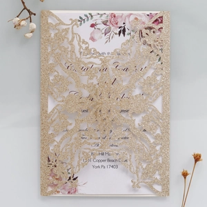 Detailed laser cut gold glitter wedding invitation with elegant floral inner card