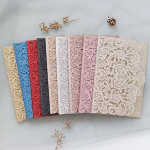 Detailed laser-cut glitter wedding invitations in multiple colors with elegant floral patterns