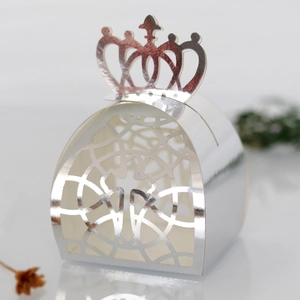 Detail of laser-cut crown gift box with intricate hollow pattern and silver mirror finish