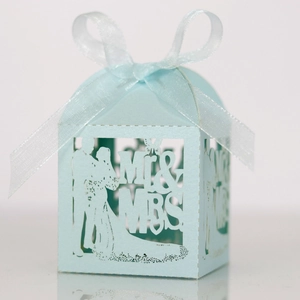 Detail view of laser-cut Mr & Mrs wedding favor box in light blue with white organza ribbon