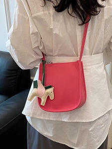 Niche rose red bucket bag in lychee grain leather with a cute pegasus charm detail