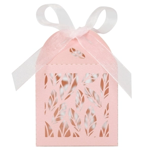 Close-up of pink laser-cut leaf pattern gift box with white organza ribbon bow
