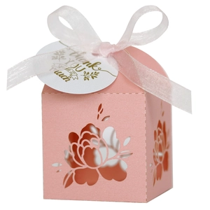 Detail of pink laser-cut rose gift box with white ribbon and a thank you tag
