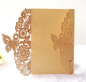Detail of laser-cut floral and butterfly patterns on luxury wedding invitations