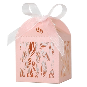 Detail of pink laser-cut gift box with leaf patterns and elegant organza ribbon bow