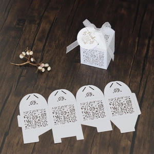 Detailed laser-cut white favor box with rose patterns, silk ribbon, and Thank You tag