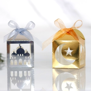Detail of laser-cut moon and star patterns on gold and silver metallic favor boxes